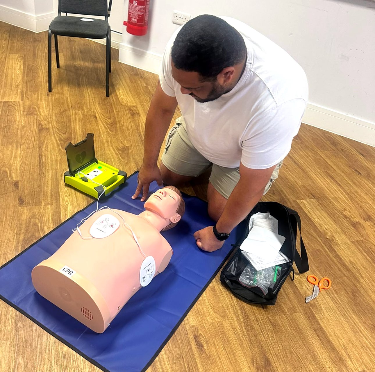 Learner preparing an AED during first aid training
