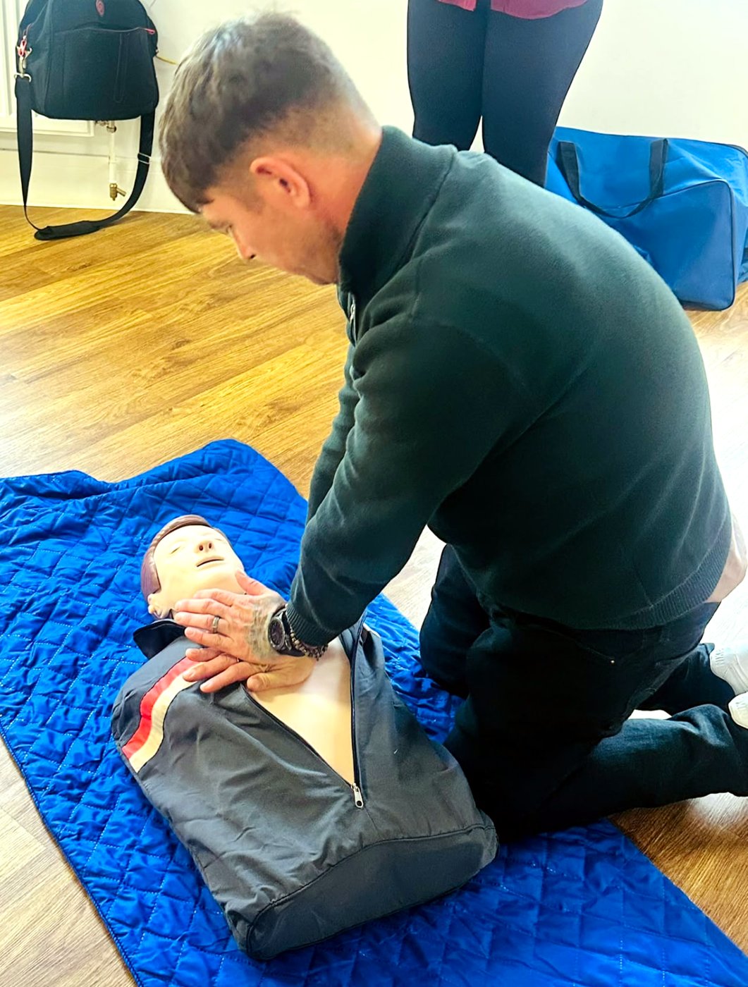 Learner practising chest compressions on a manikin
